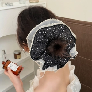 Oversized polka dot mesh scrunchie with lace trim shown on a low hair bun