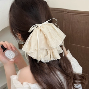 Elegant cream organza hair claw with lace ruffles, pearls and a sweet ribbon bow