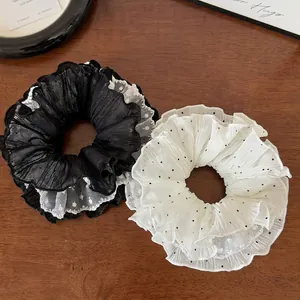Set of two black and white ruffled organza hair scrunchies with polka dot lace trim