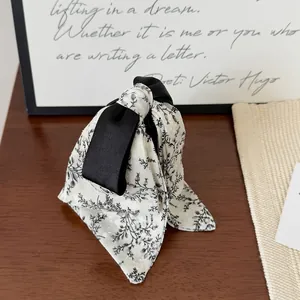Elegant black and white floral print ribbon hair claw clip for a minimalist style
