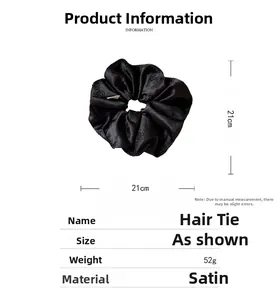 Detailed view of large black satin scrunchie with camellia rose pattern and size measurement