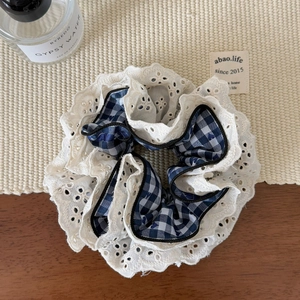 Detail of Korean style blue checkered hair scrunchie with white lace embroidery edges