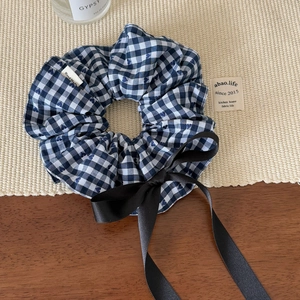 Detail of blue gingham scrunchie with long black satin bow and Hand Made label