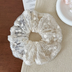 Elegant cream lace scrunchie with floral embroidery and clear bead trim for ponytails