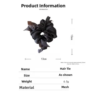Detail view of a 13cm black mesh bow scrunchie showing light fabric texture and dimensions