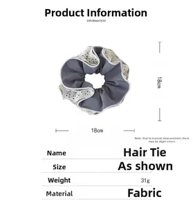 Detail view of a 18cm blue plaid scrunchie with lace trim on white background