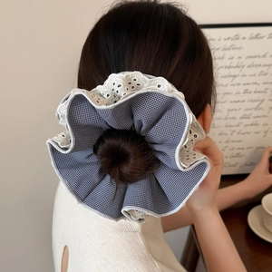 Chic checkered hair scrunchie with white lace embroidery detail shown on wrist