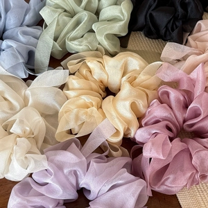Detail of soft organza silk hair scrunchies with long ribbons in assorted pastel colors