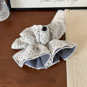 Elegant four-layer grid hair scrunchie with floral embroidery on wooden surface