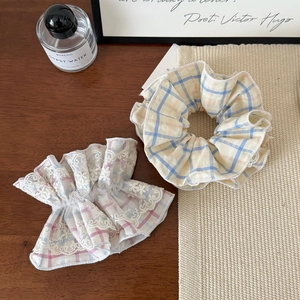Set of two plaid scrunchies with yellow and blue patterns and delicate white lace trim