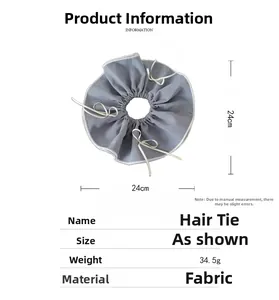Detail of grey plaid scrunchie with lace trim and white ribbon bow 24cm diameter