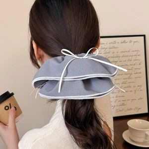Chic grey plaid oversized double-layered bow hair scrunchie shown on a female model