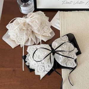 Elegant French lace bow hair clip with pearls for low ponytail or half-up hairstyles