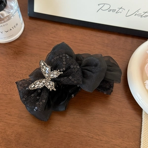 Close-up of black mesh butterfly hair claw clip with sparkly silver rhinestone accents