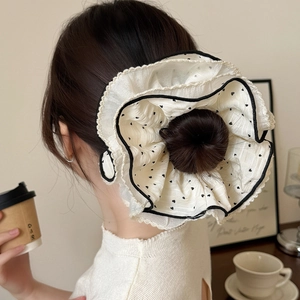 Polka dot oversized white chiffon scrunchie with black contrast trim on bun hair