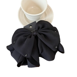 Elegant black oversized bow hair claw clip with rhinestones and luxury chiffon texture