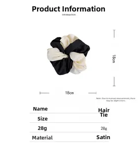 Detail view of large 18cm black and white patchwork satin scrunchie with size specifications