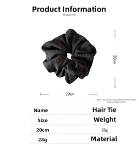 Detailed view of black fabric hair scrunchie with dimensions 20cm and weight 28g