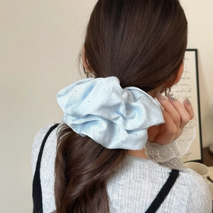 Light blue oversized fabric scrunchie with sparkling rhinestones and pleated texture