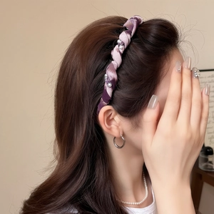 Elegant purple wave headband with pearls and rhinestones on a model in soft lighting