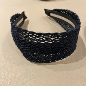 Detail view of deep blue woven wide headband with silver anti-slip lining and protective tips