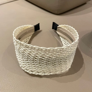 Detailed close-up of bohemian hollow woven wide headband in beige cream color