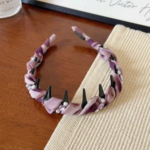 Detail of purple floral headband featuring alternating faux pearls and sparkling rhinestones