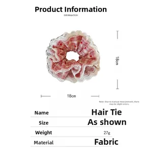 Detail view of 18cm pink plaid scrunchie with white lace trim and red heart prints