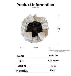 Detailed view of oversized polka dot mesh hair scrunchie with size and weight specifications