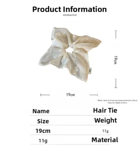 Detail view of beige mesh hair scrunchie with 19cm diameter and rose embroidery