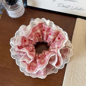 Sweet pink plaid lace hair scrunchie with heart embroidery on a wooden table