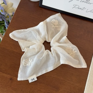 Detail of cream white mesh hair scrunchie featuring elegant rose flower embroidery