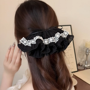 Elegant black pleated bow hair clip with white lace trim for a French vintage hair style