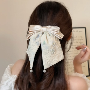 French lace bow hair clip with pearls and elegant champagne satin embroidery texture