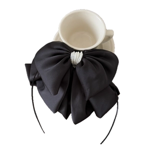 Elegant large black satin bow hair clip with white pearl center for ponytail styling