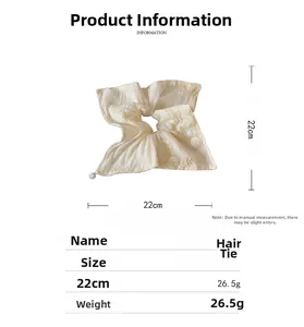 Detailed view of cream floral mesh scrunchie with 22cm size specs and pearl detail