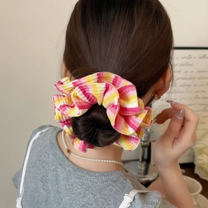 Colorful striped oversized scrunchie for hair styling on a bun hairstyle
