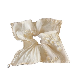 Beige floral embroidered mesh scrunchie with a delicate white pearl pendant detail