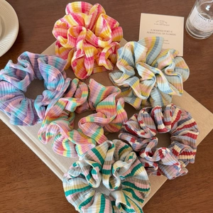 Set of six colorful striped scrunchies for bun hairstyles in sweet dopamine style