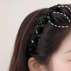 Elegant black beaded headband with shimmering sequins on model with long brown hair