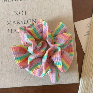 Macro shot of colorful striped ribbed scrunchie with elastic hair tie texture