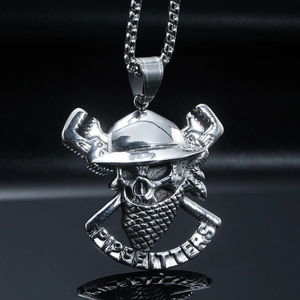 Macro shot of vintage steel pirate skull pendant with Pipefitters engraving and box chain