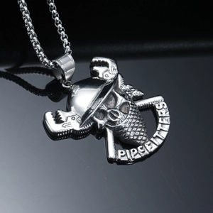 Macro view of stainless steel skull pendant with pipefitters design and crossed wrenches