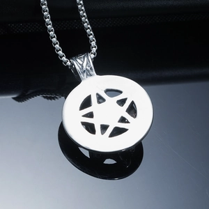 Macro shot of silver stainless steel star pendant with classic box chain texture