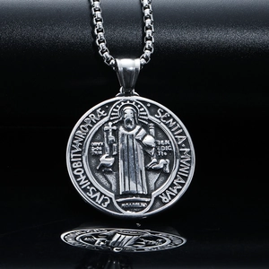 Macro detail of vintage Saint Benedict exorcism pendant with Latin inscriptions