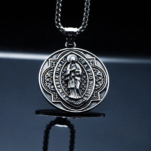 Detailed macro of vintage religious Virgin Mary pendant with intricate embossed text
