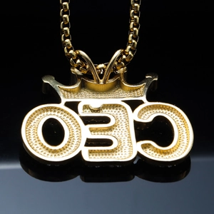 Golden CEO crown pendant necklace with box chain for men on a black background