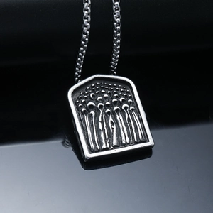 Macro shot of punk grim reaper reaper cloak pendant in antique silver stainless steel
