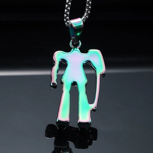 Macro shot of colorful iridescent robot pendant on a silver box chain with black reflection
