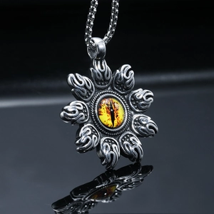 Vintage steel pendant featuring a yellow dragon eye and flame engraving on a black base